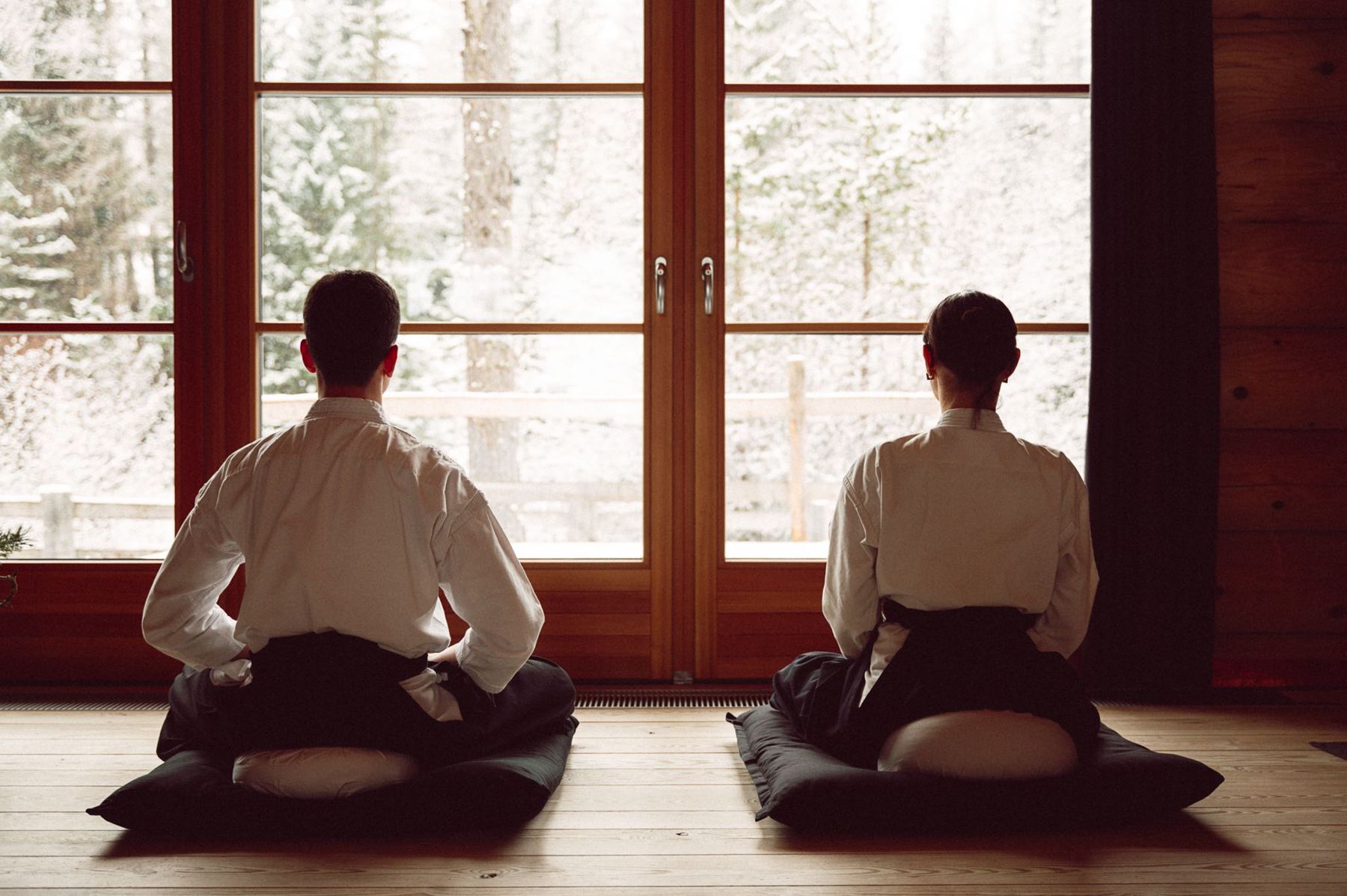 Due praticanti in zazen davanti alla finestra del dojo, fuori la neve
